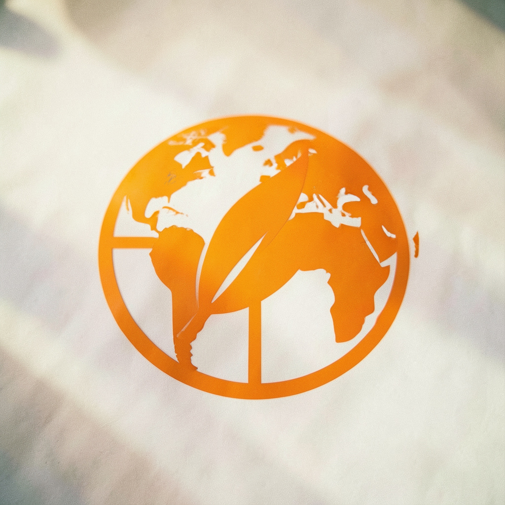 Stylized icon of a globe with a leaf, representing environmental responsibility and global sustainability.